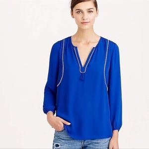 J.Crew blue blouse with small tassel and blue and white stitching